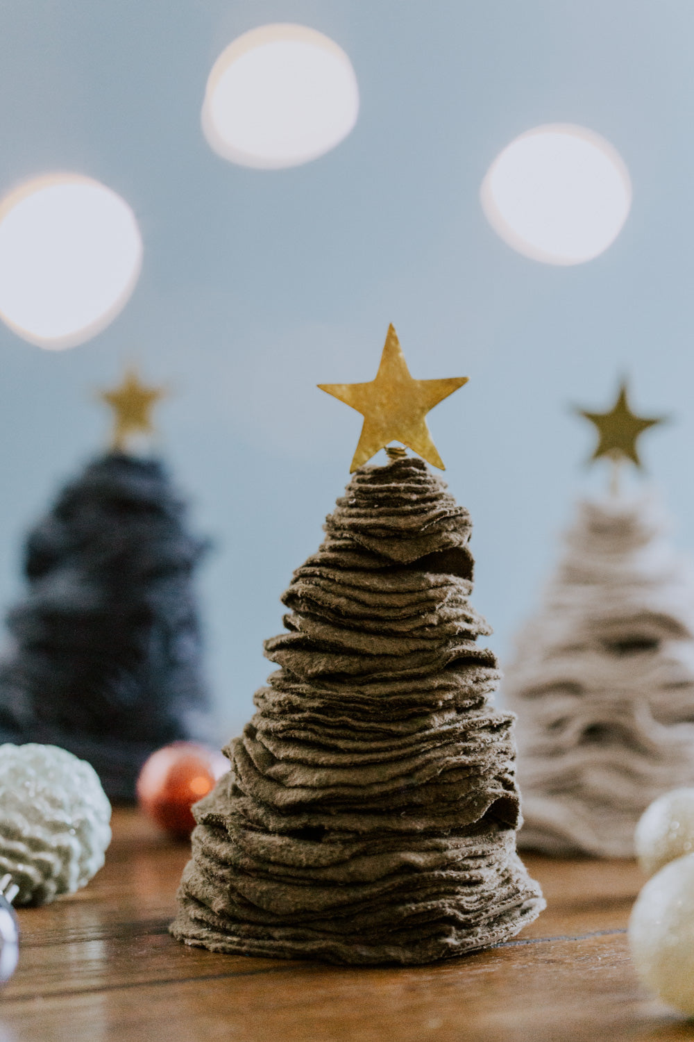 Ethical fair trade upcycled stacked sweater Christmas tree handmade by Grain of Rice Project artisans in Kibera slum, Kenya | This tree is brown in color and has a brass star topper.