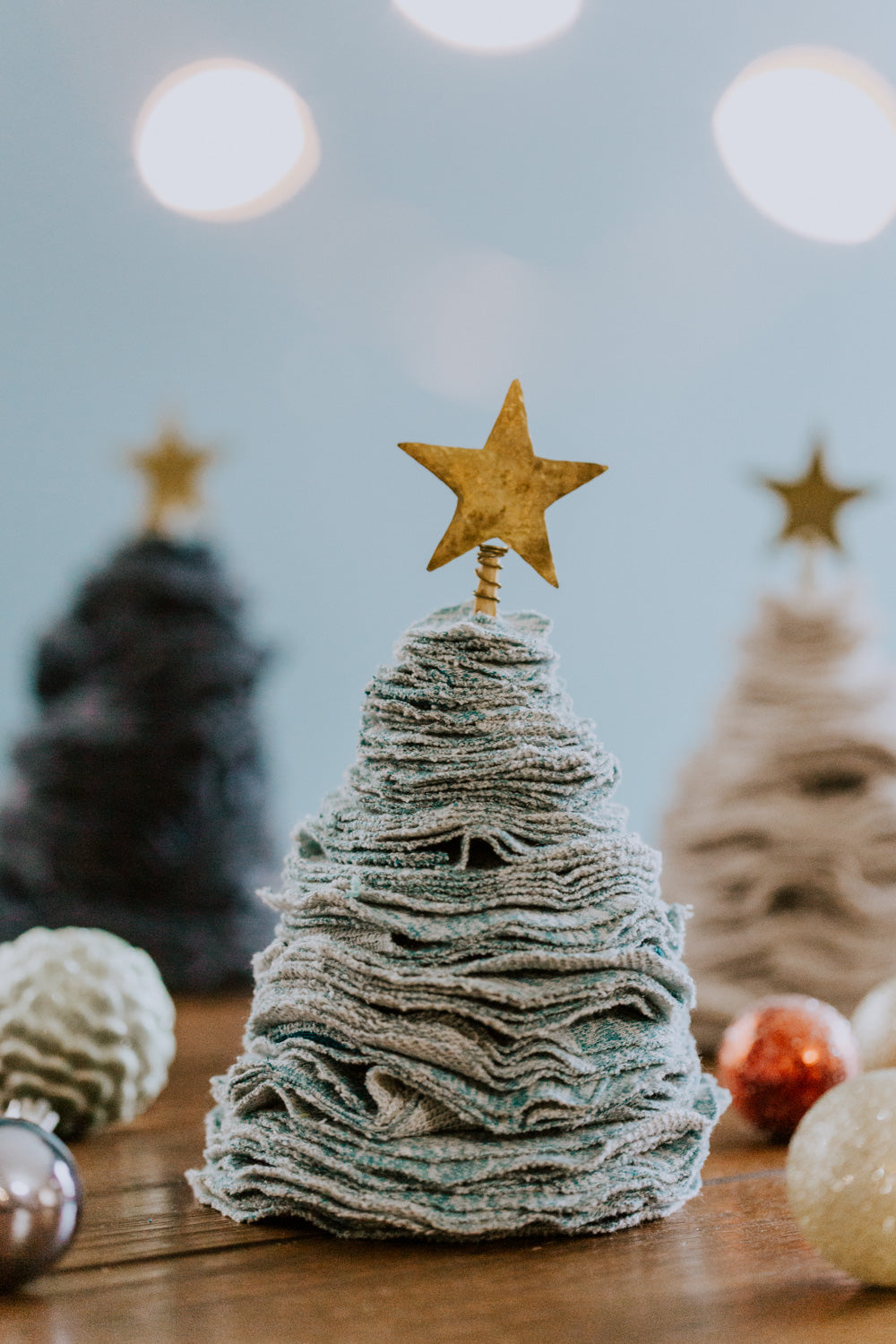 Ethical fair trade upcycled stacked sweater Christmas tree handmade by Grain of Rice Project artisans in Kibera slum, Kenya | This tree is aqua heather in color and has a brass star topper.