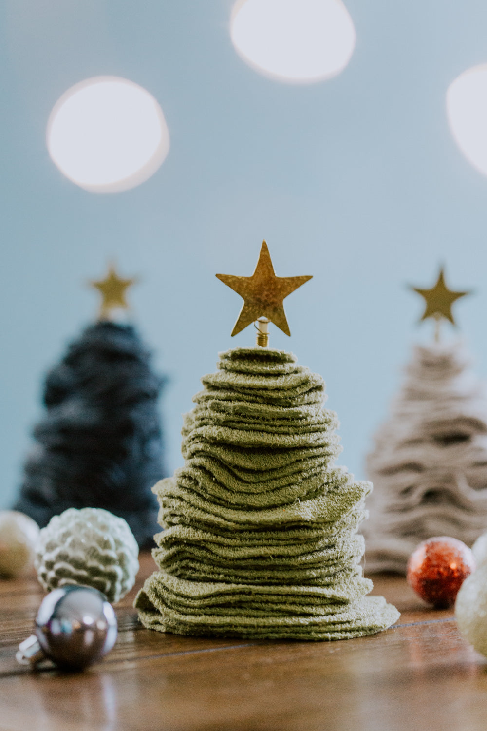 Ethical fair trade upcycled stacked sweater Christmas tree handmade by Grain of Rice Project artisans in Kibera slum, Kenya | This tree is olive green in color and has a brass star topper.